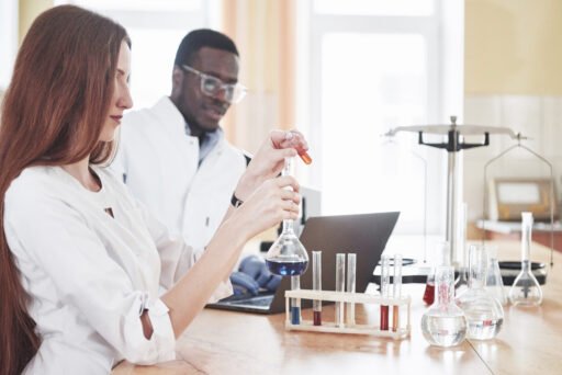 Laboratory laboratories conduct experiments in a chemical laboratory in transparent flasks. Output formulas.